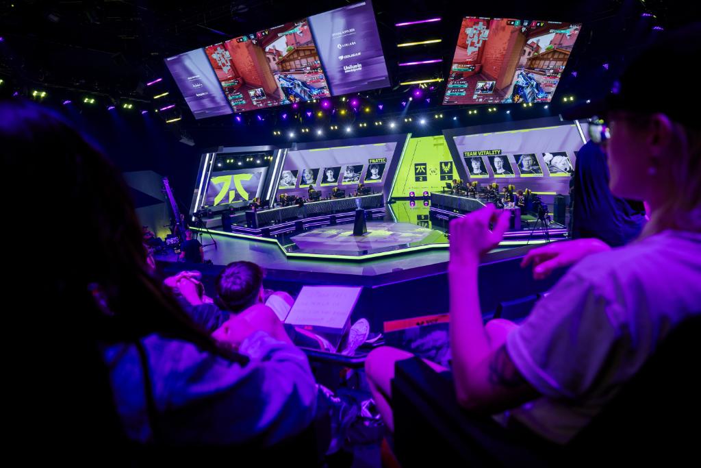 Riot Games multi-city product launch — arena stage under lighting rig