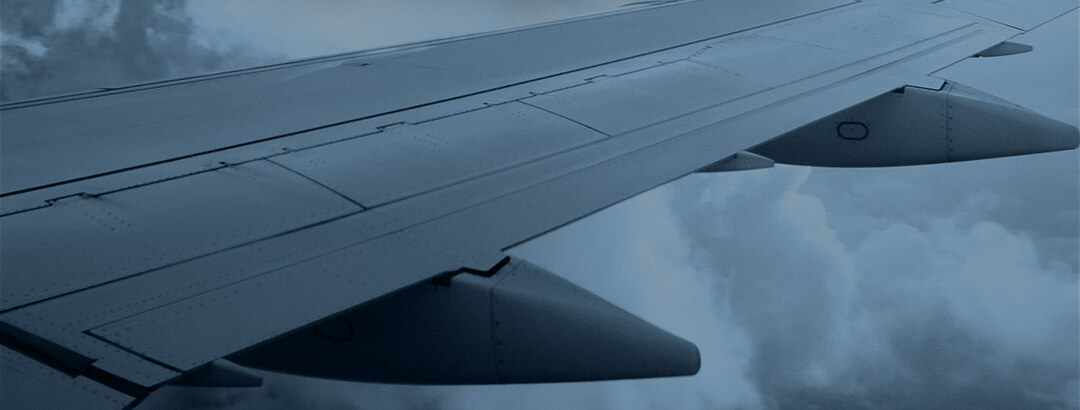 Transportation & Logistics — aircraft wing above clouds